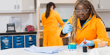 Science student holding a digital pipette