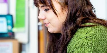 student in a green top