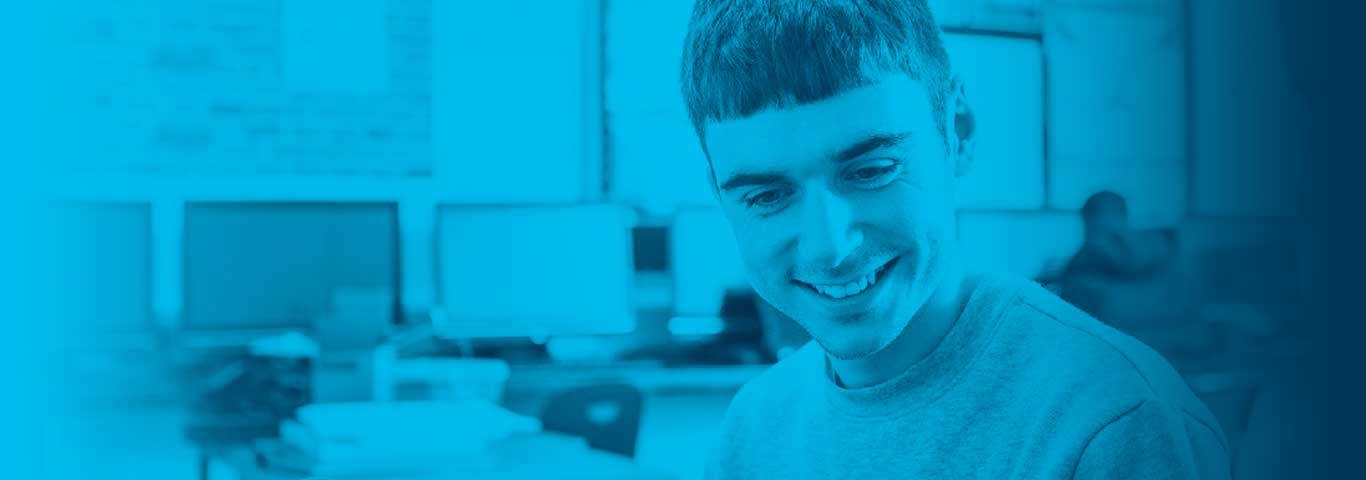 student looking down smiling, blue overlay