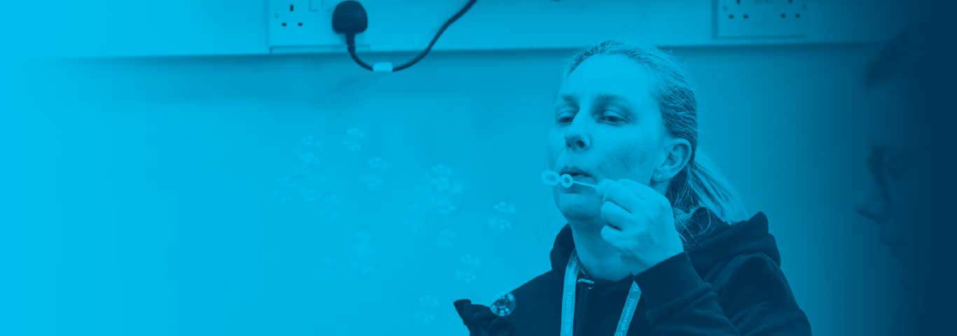 person blowing bubbles, blue overlay