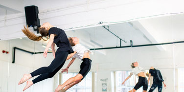 dance students jump in synchronicity 