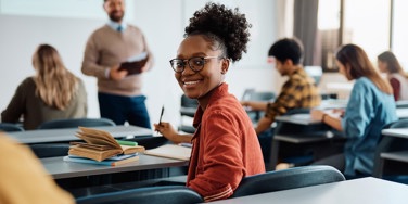 Student turns to back of class smiling during lecture
