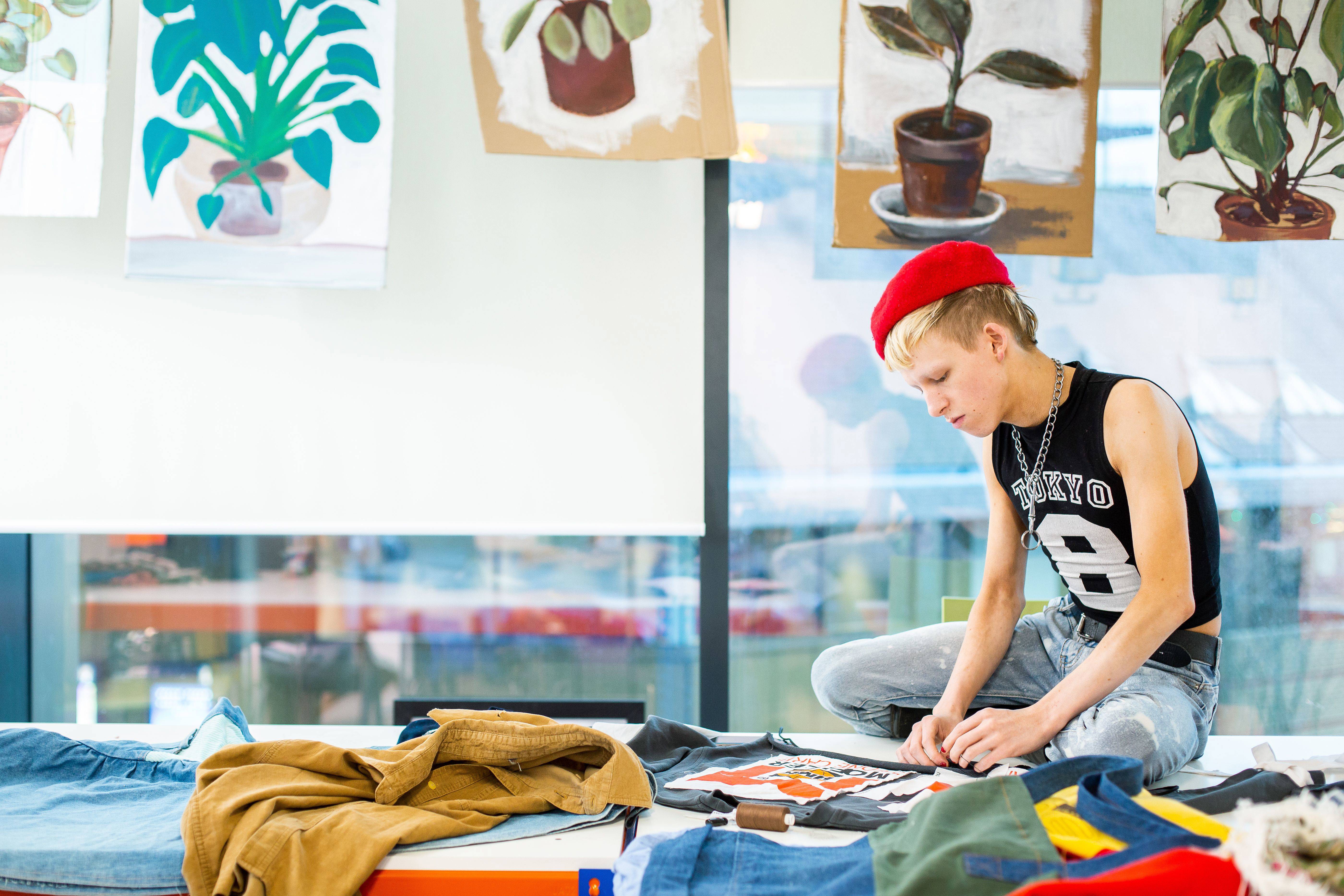 fashion student looking at clothes layed out