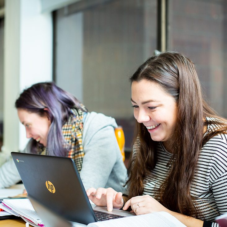two students working on their chromebooks