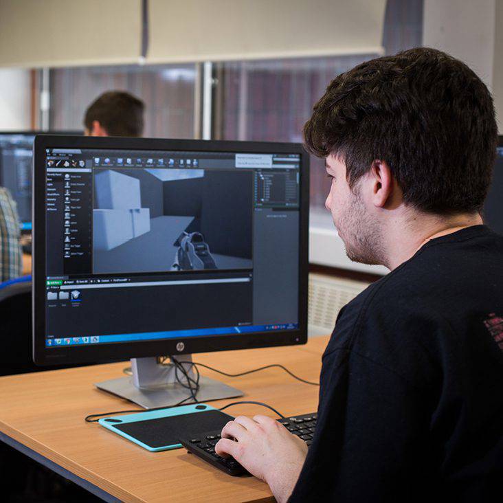 student sat at computer working on some 3d modelling