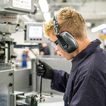 student drills something in an engineering bay