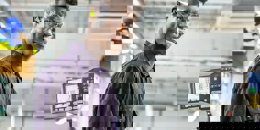 Student in overalls in an engineering bay