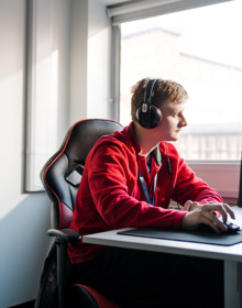 student sat at a computer with headset on